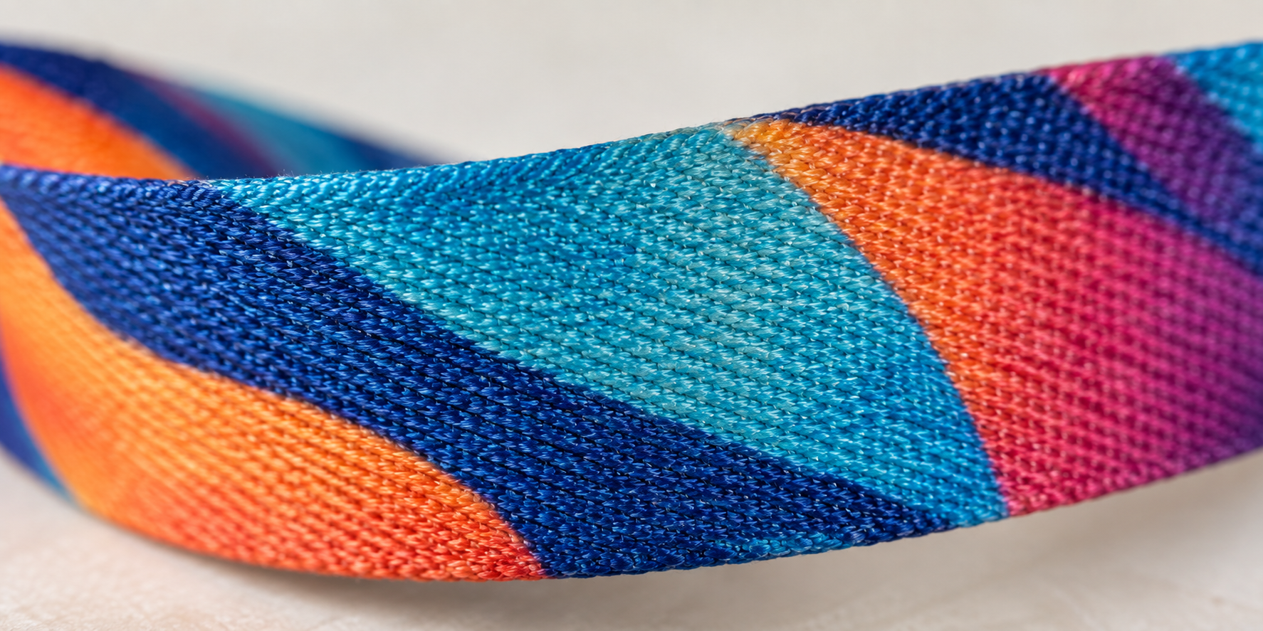 A close-up macro shot of a dye-sublimated lanyard showing the ink infused into the fabric fibers