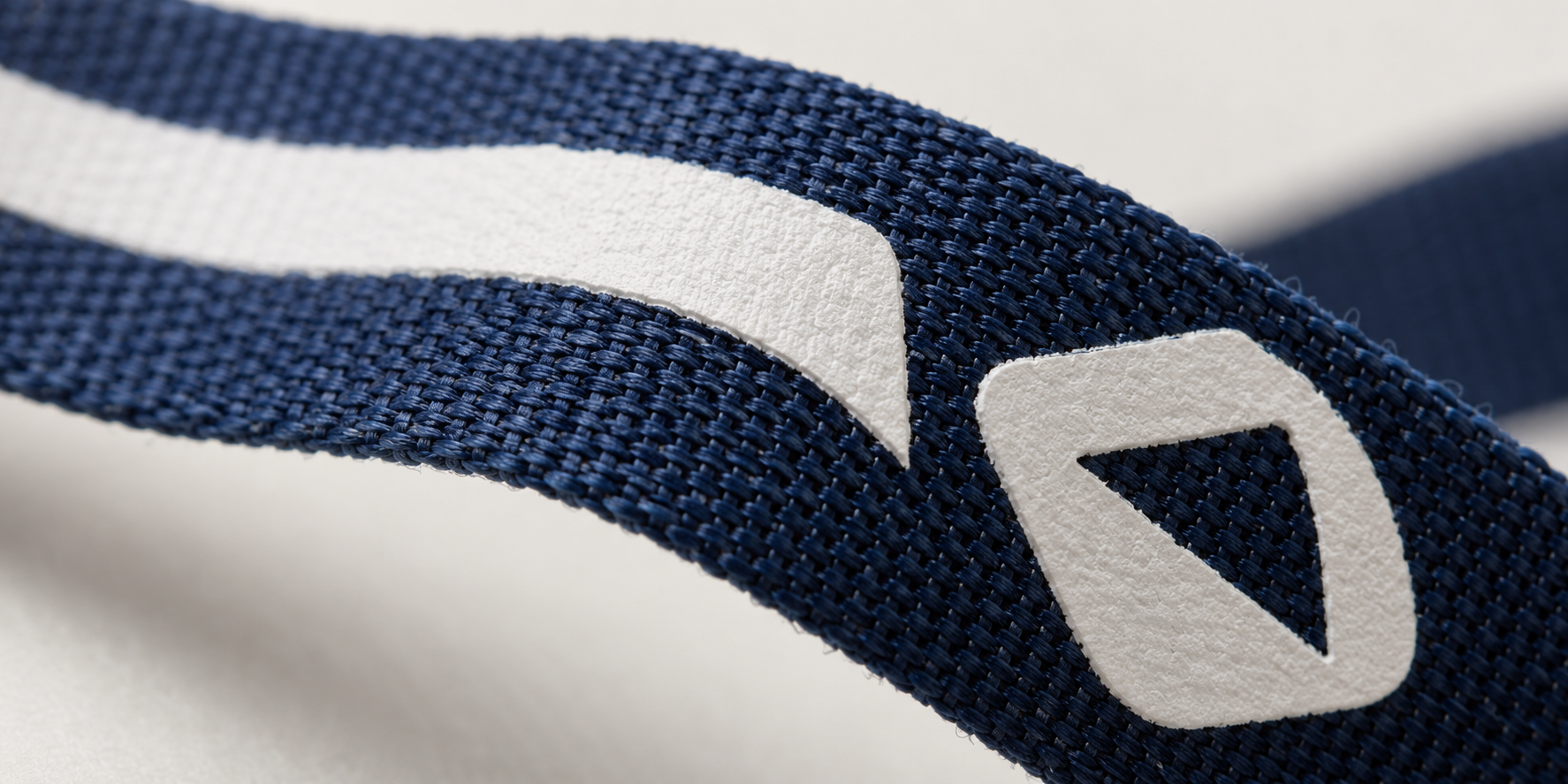 A close-up shot of a screen-printed lanyard showing the slightly raised ink layer on top of the fabric
